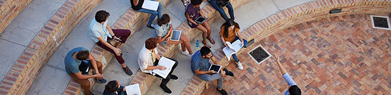 Students sitting outside with notebooks