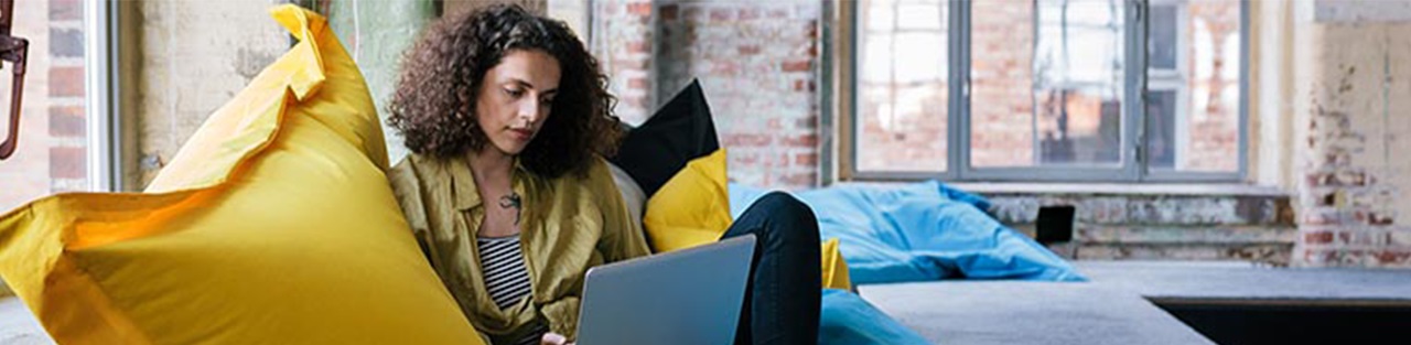 Woman sitting in couch and using laptop