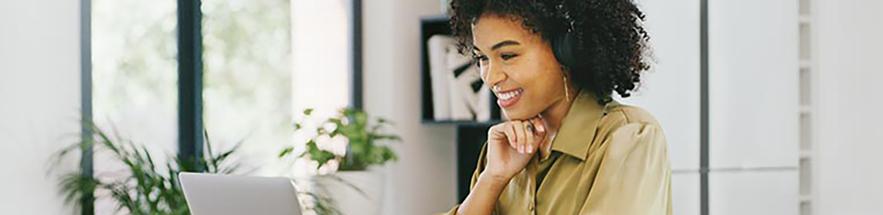 Woman looking at laptop and smiling