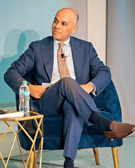 Amit Sevak seated in a chair during a speaking engagement.